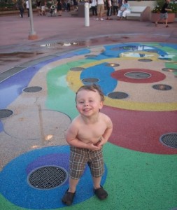 Brayden playing in fountain disney